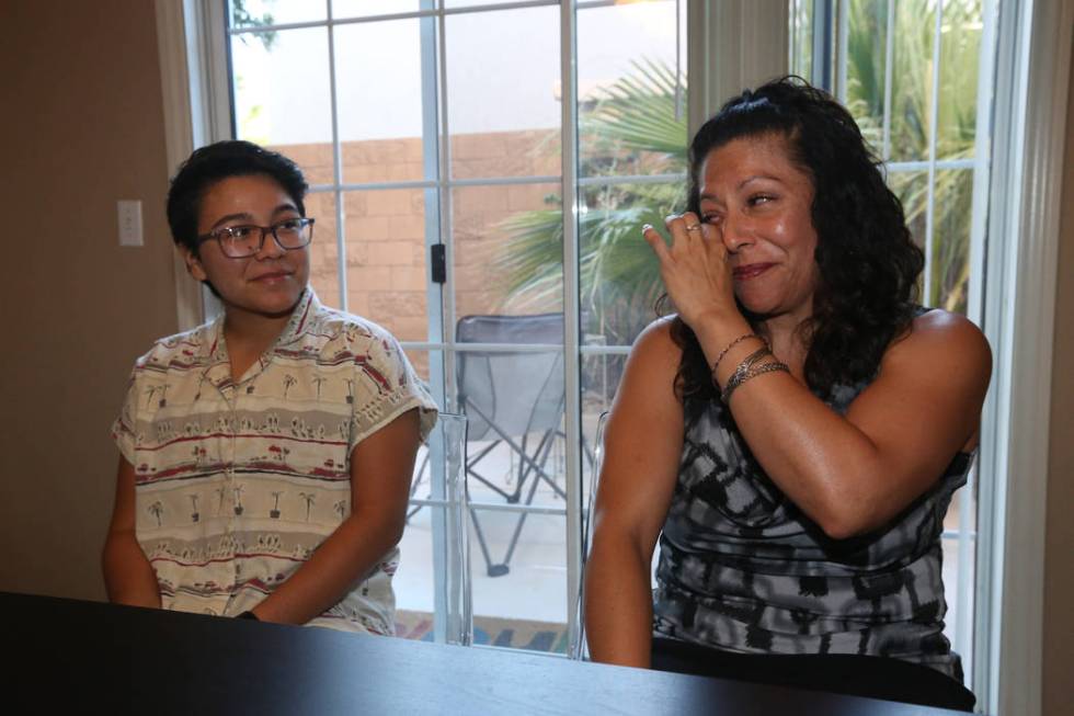 Percy Neavez watches as his mother, Brenda, cries while discussing her son's transition at thei ...