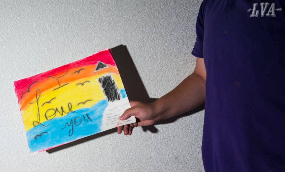 Fifteen-year-old Ryan Lauer shows artwork he made for his sister at home near downtown Las Vega ...