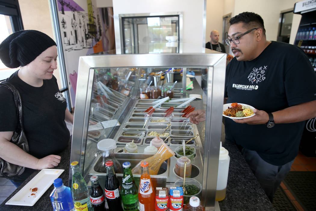 Chef and co-owner Paras Shah, right, makes a custom bowl for Michelle Ziegenhagen at Valencian ...