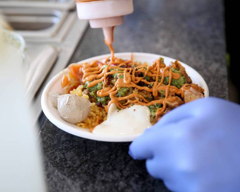 Chef and co-owner Jeffrey Weiss sauces a custom bowl at Valencian Gold in Las Vegas Thursday, J ...