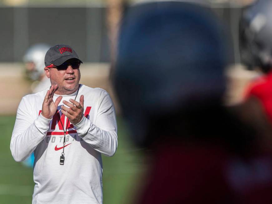 UNLV head football coach Tony Sanchez, left, fires up his team during the first day of training ...