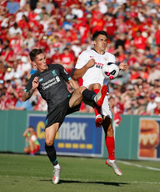 Liverpool's Harry Wilson, left, and Sevilla's Reguilon Rodriguez Sergio vie for the ball during ...