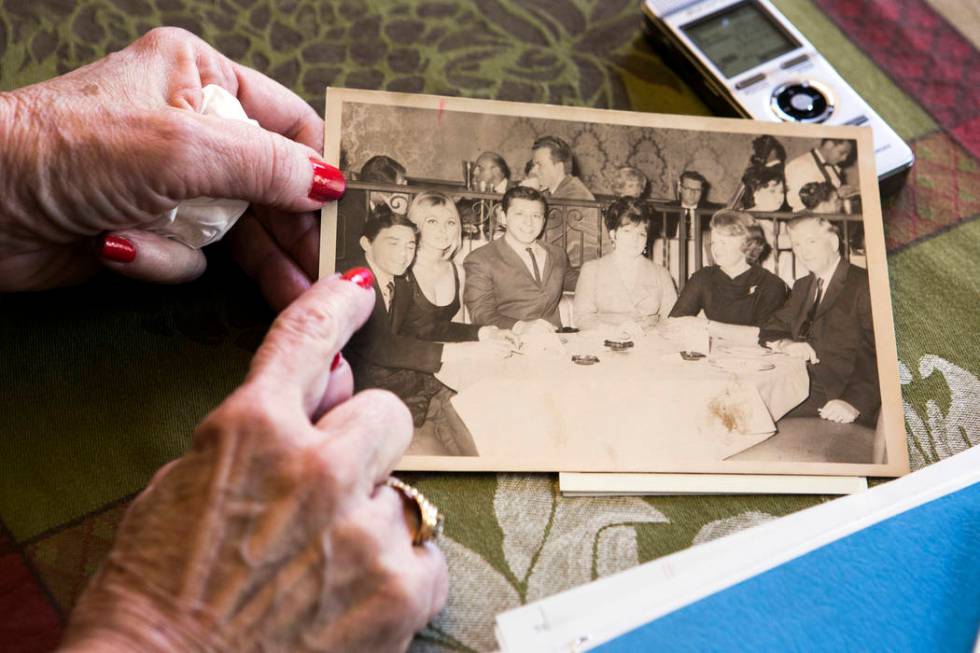 Peggy DiMaria look at an old family photo of her brother, Jay Sebring, when he was visiting the ...