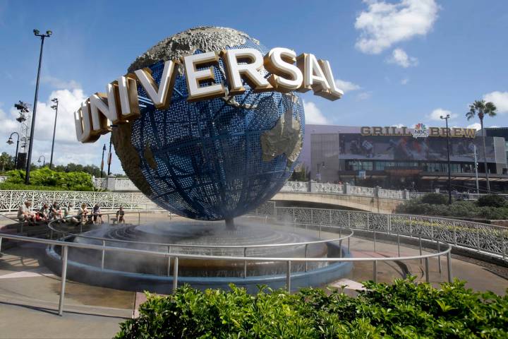 In this Oct. 22, 2015,file photo, park guests relax and cool off with a water mist under the gl ...