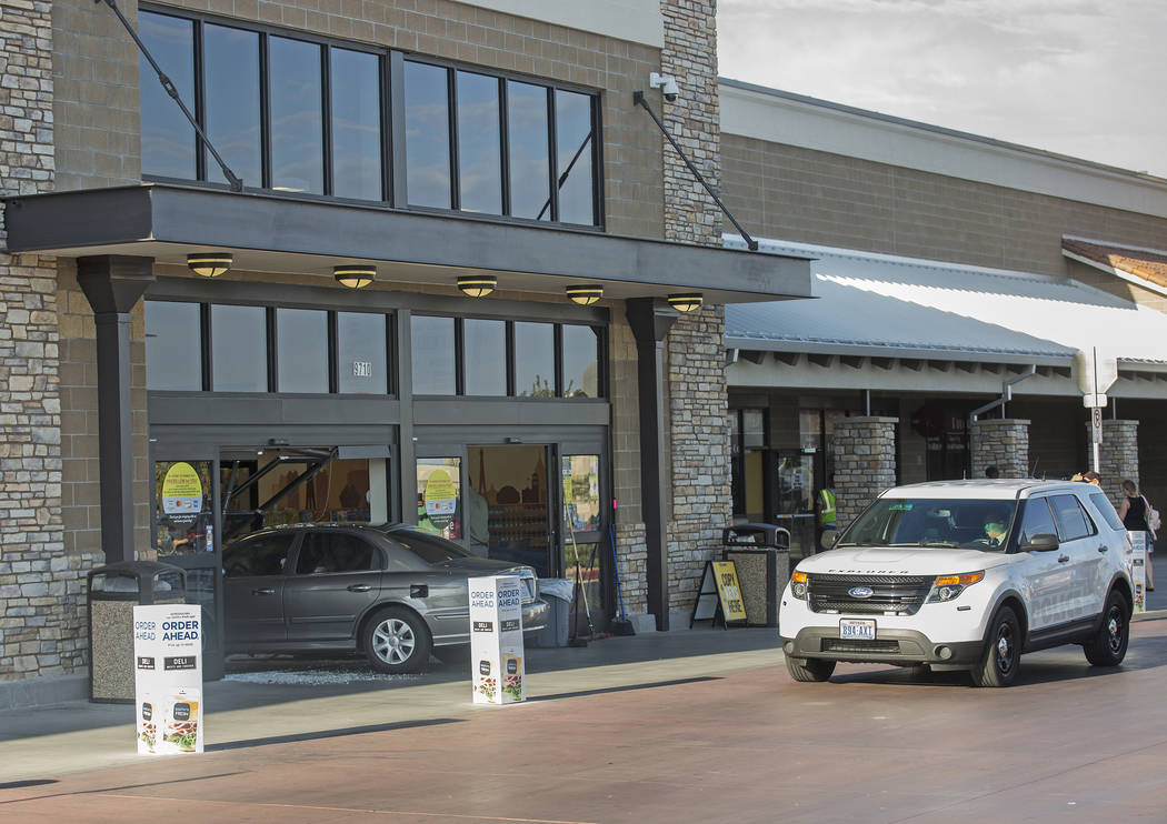 A car crashes into the Smith's Marketplace, at 9710 West Skye Canyon Park Drive, Wednesday, Jul ...