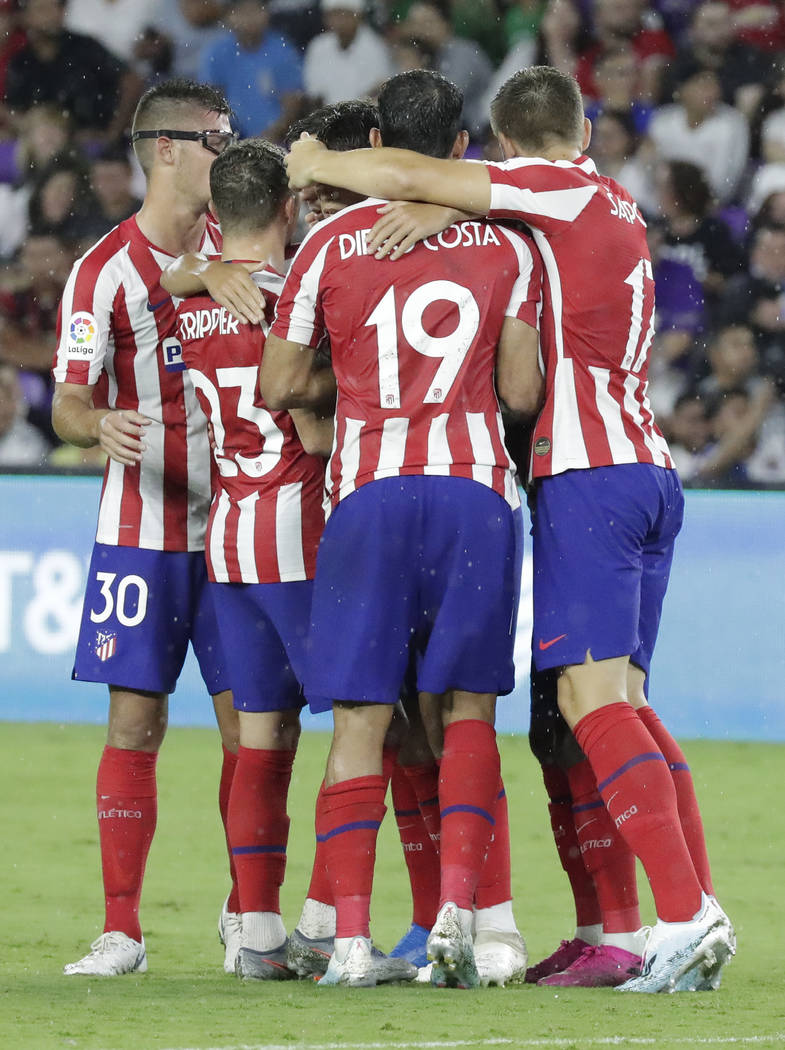 Atletico Madrid forward Joao Felix is surrounded by teammates after scoring a goal against the ...