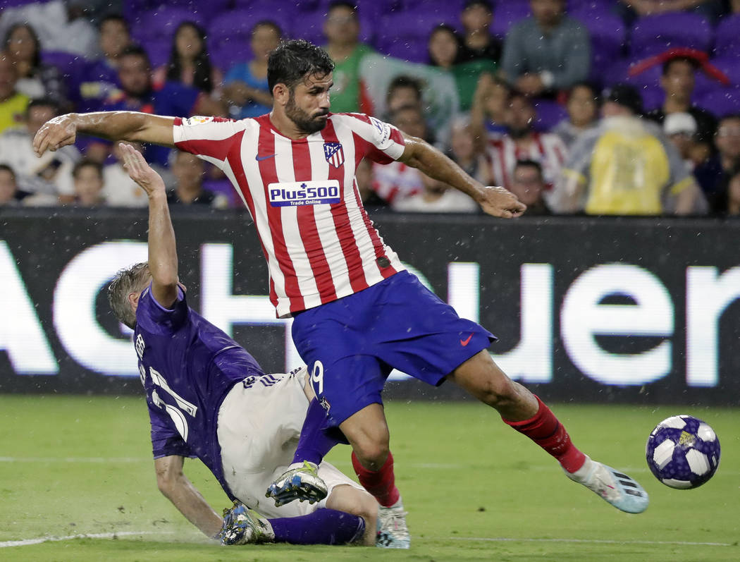 Atletico Madrid forward Diego Costa, right, scores a goal as he gets off a shot past Chicago Fi ...