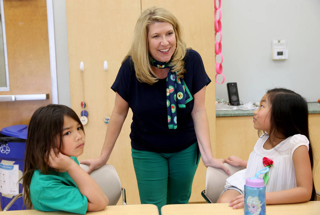 Kimberly Trueba, CEO of Girl Scouts of Southern Nevada, visits with Allyson Santori, 8, left, a ...