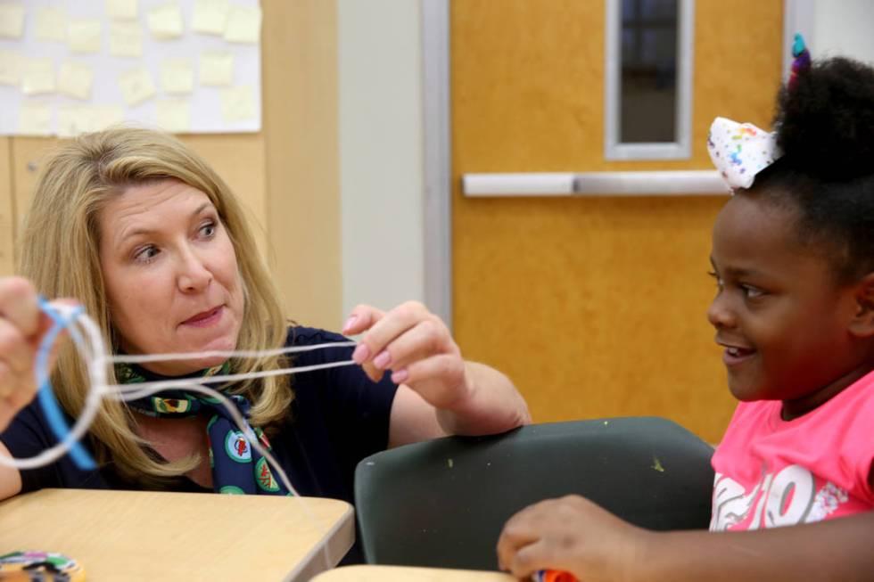 Kimberly Trueba, CEO of Girl Scouts of Southern Nevada, makes a dreamcatcher with Qris'lya &quo ...