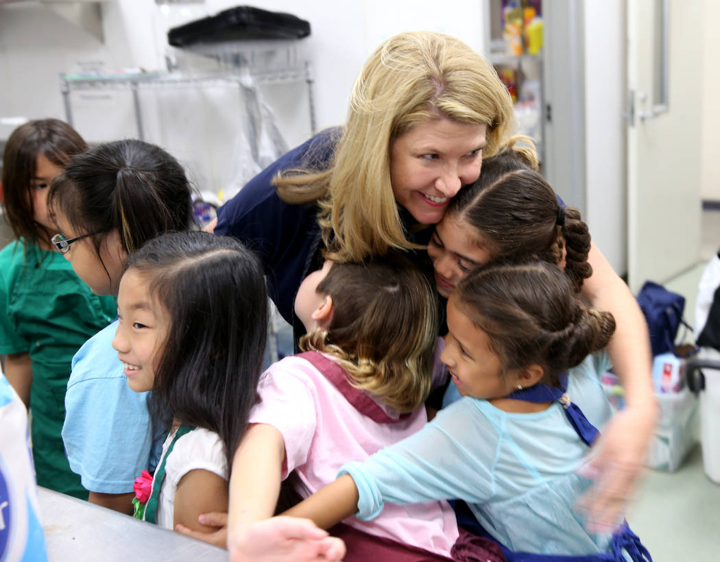 Kimberly Trueba, CEO of Girl Scouts of Southern Nevada, visits with, from left, Allyson Santori ...