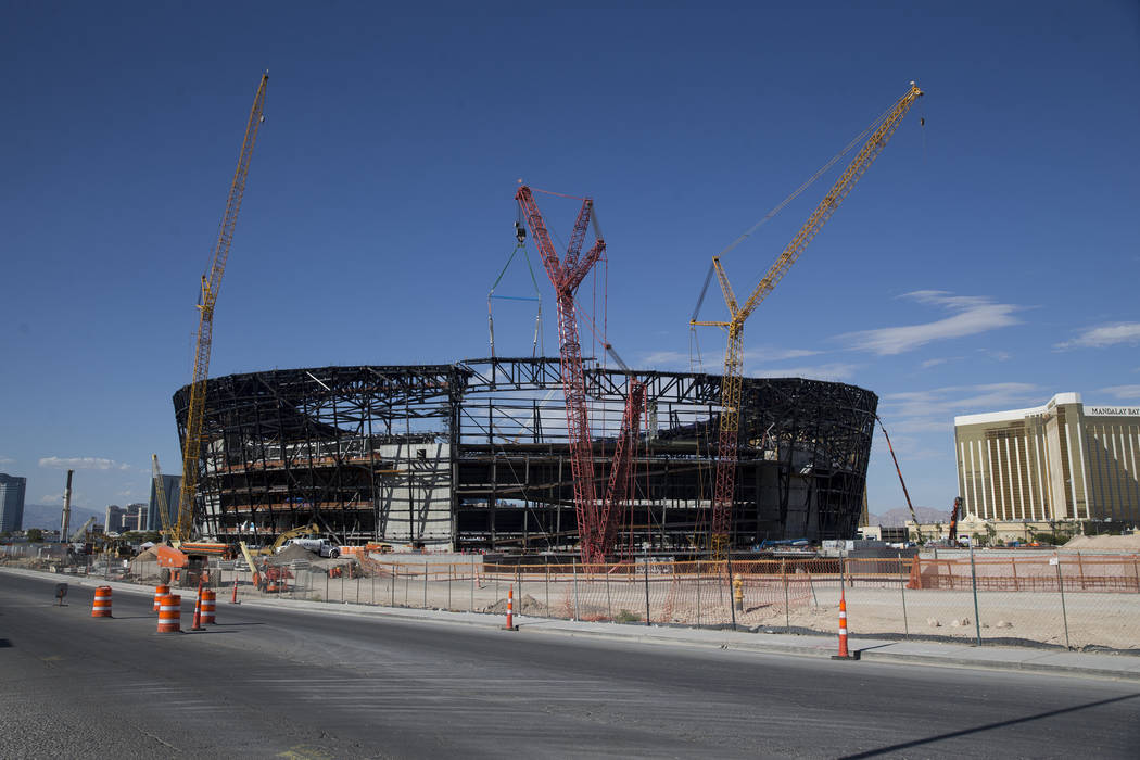 The final steel canopy truss goes up at the Raider stadium construction site in Las Vegas, Thur ...