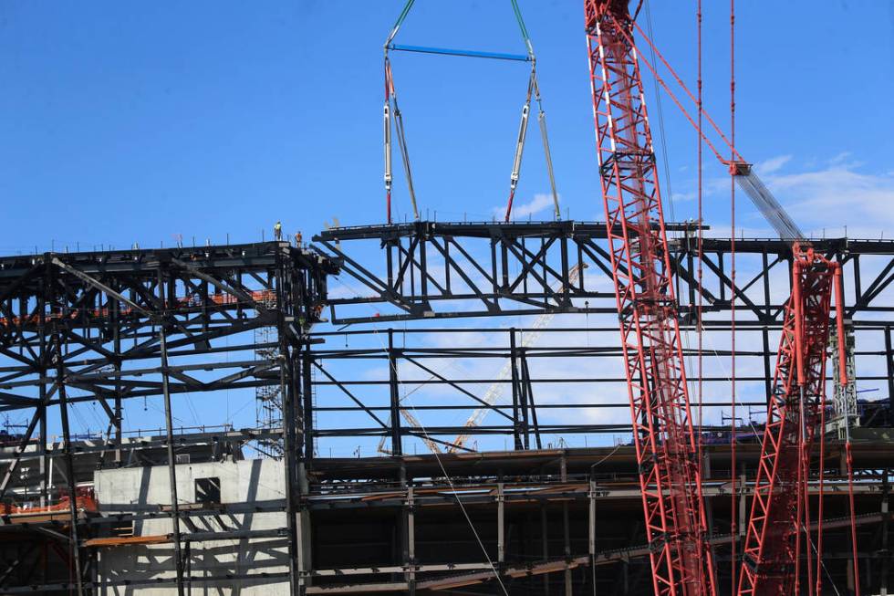 The final steel canopy truss goes up at the Raider stadium construction site in Las Vegas, Thur ...