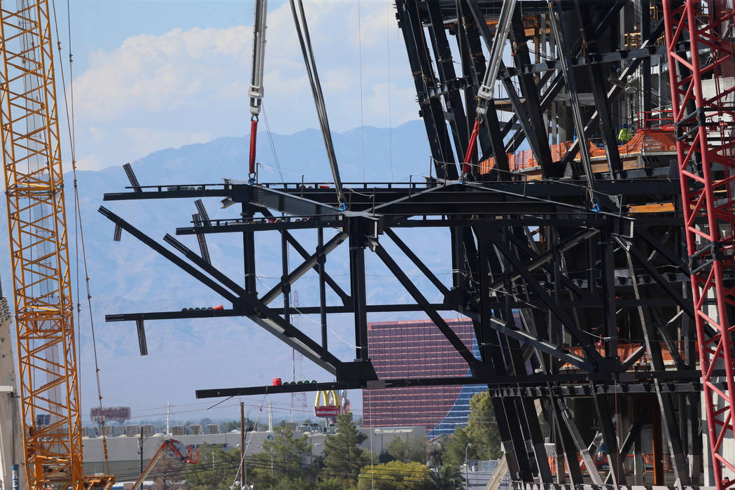The final steel canopy truss goes up at the Raider stadium construction site in Las Vegas, Thur ...