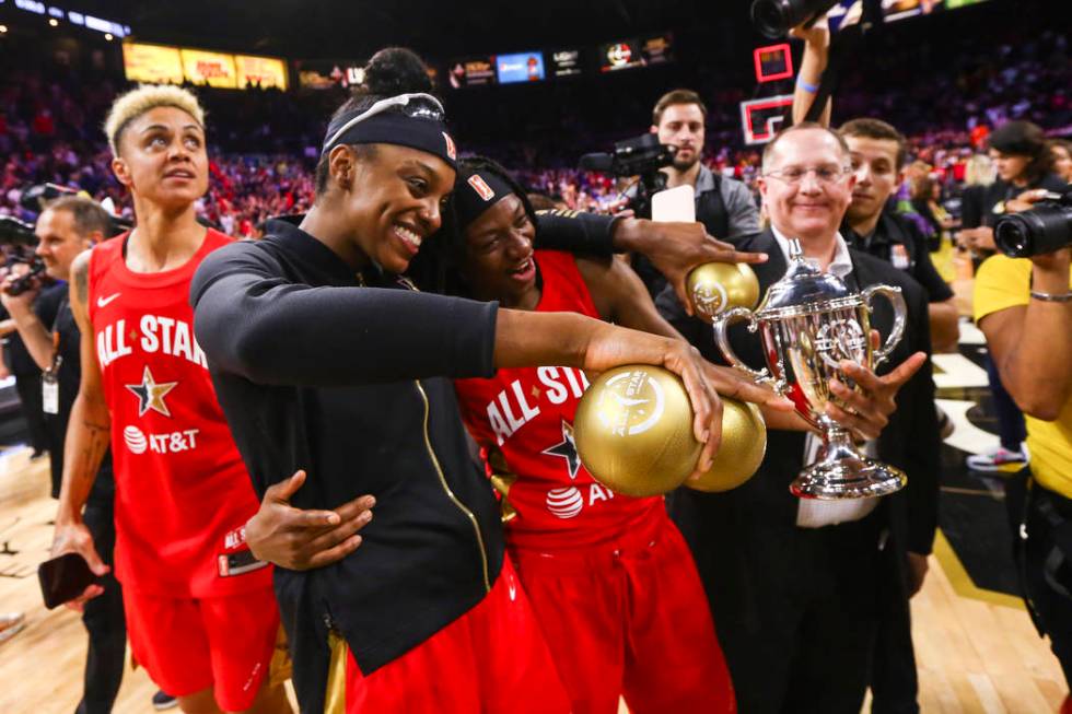 Chicago Sky's Diamond DeShields, center/left, celebrates with Indiana Fever's Erica Wheeler aft ...