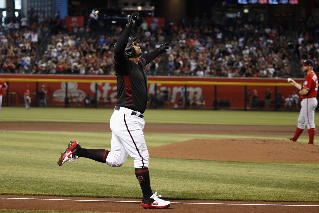 Arizona Diamondbacks' Eduardo Escobar, left, celebrates his two-run home run against Washington ...