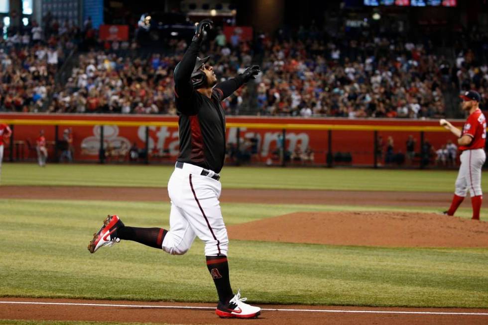 Arizona Diamondbacks' Eduardo Escobar, left, celebrates his two-run home run against Washington ...