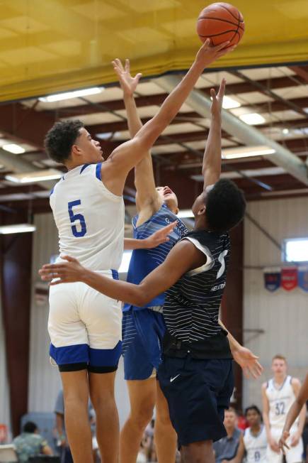 Las Vegas Knicks' Anthony Swift (5) shoots the ball under pressure in a basketball game against ...