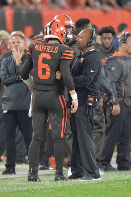 Cleveland Browns quarterback Baker Mayfield talks with head coach Hue Jackson during an NFL foo ...