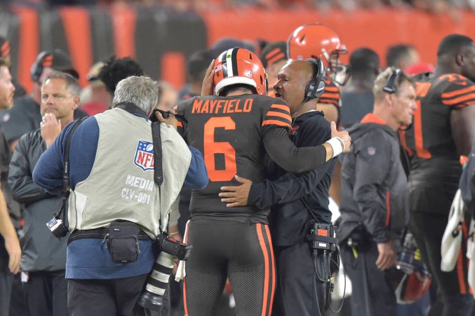 Cleveland Browns quarterback Baker Mayfield talks with head coach Hue Jackson during an NFL foo ...