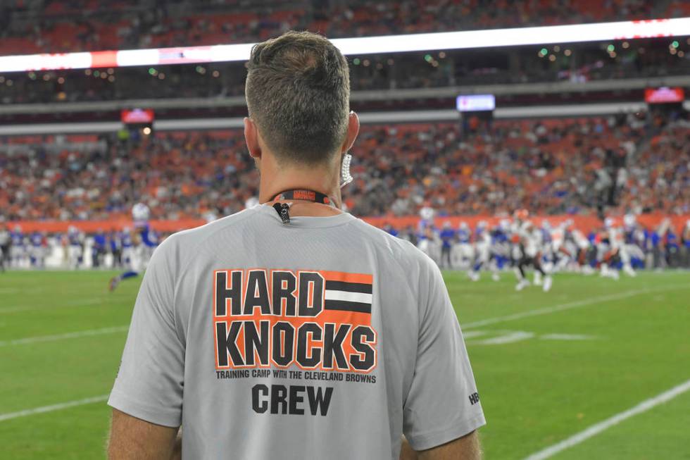 A crew member of the HBO series Hard Knocks stands on the sideline during an NFL football prese ...