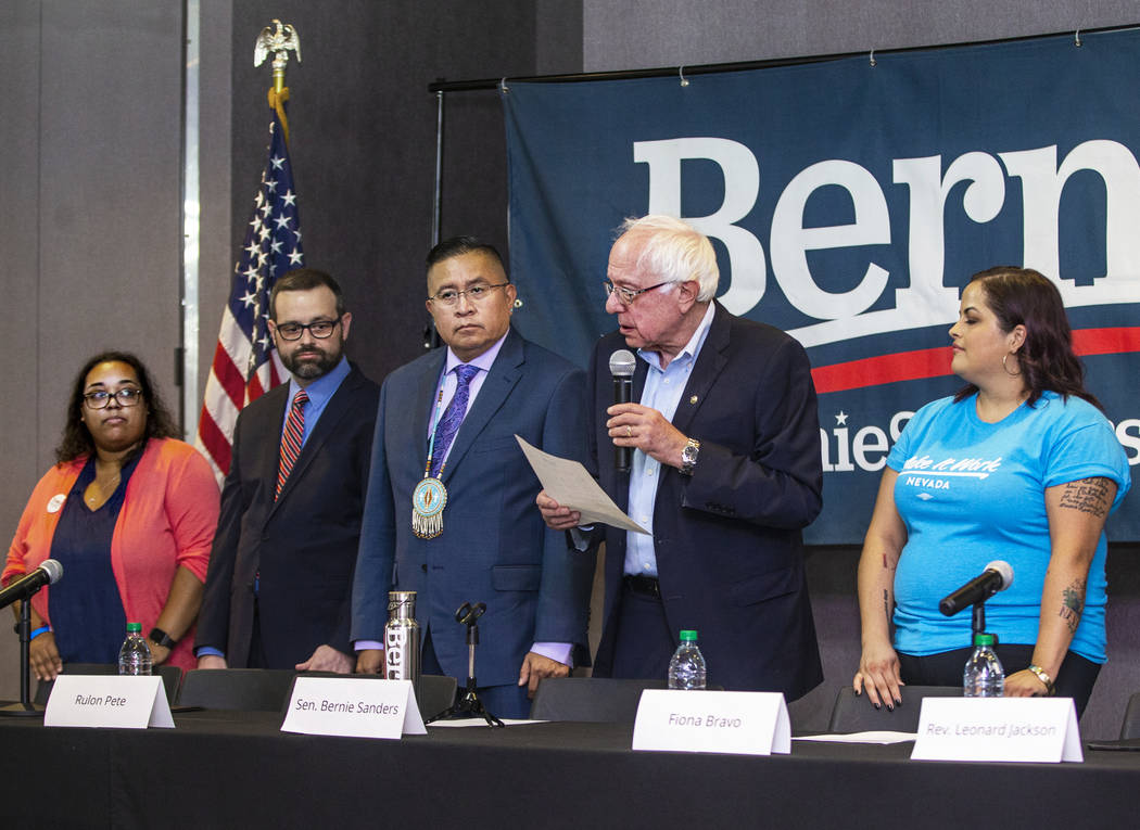 Democratic presidential candidate Sen. Bernie Sanders, I-Vt., center, introduces his panel memb ...