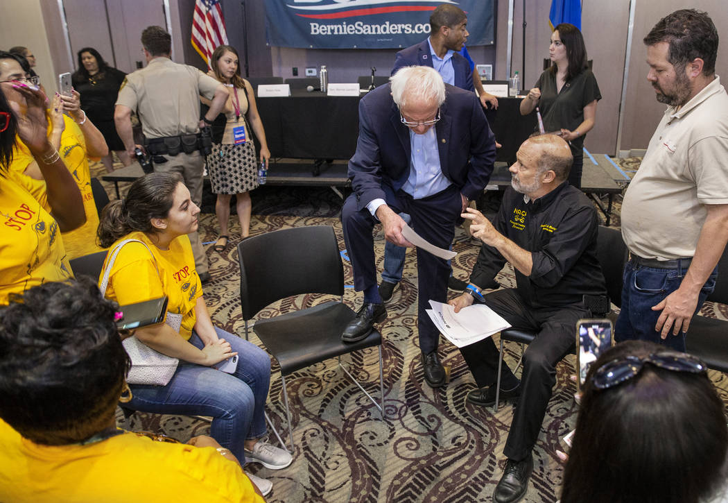 Democratic presidential candidate Sen. Bernie Sanders, I-Vt., top/center, listens to an idea by ...