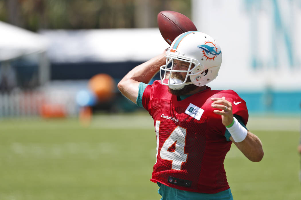 Miami Dolphins Miami Dolphins' Ryan Fitzpatrick passes as he runs drills at the teams NFL footb ...