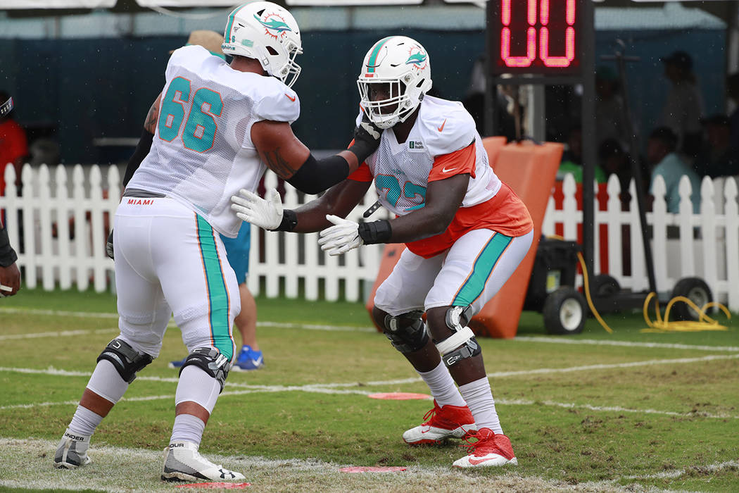 Miami Dolphins offensive tackles Aaron Monteiro (66) and Isaiah Prince (72) run drills at the t ...