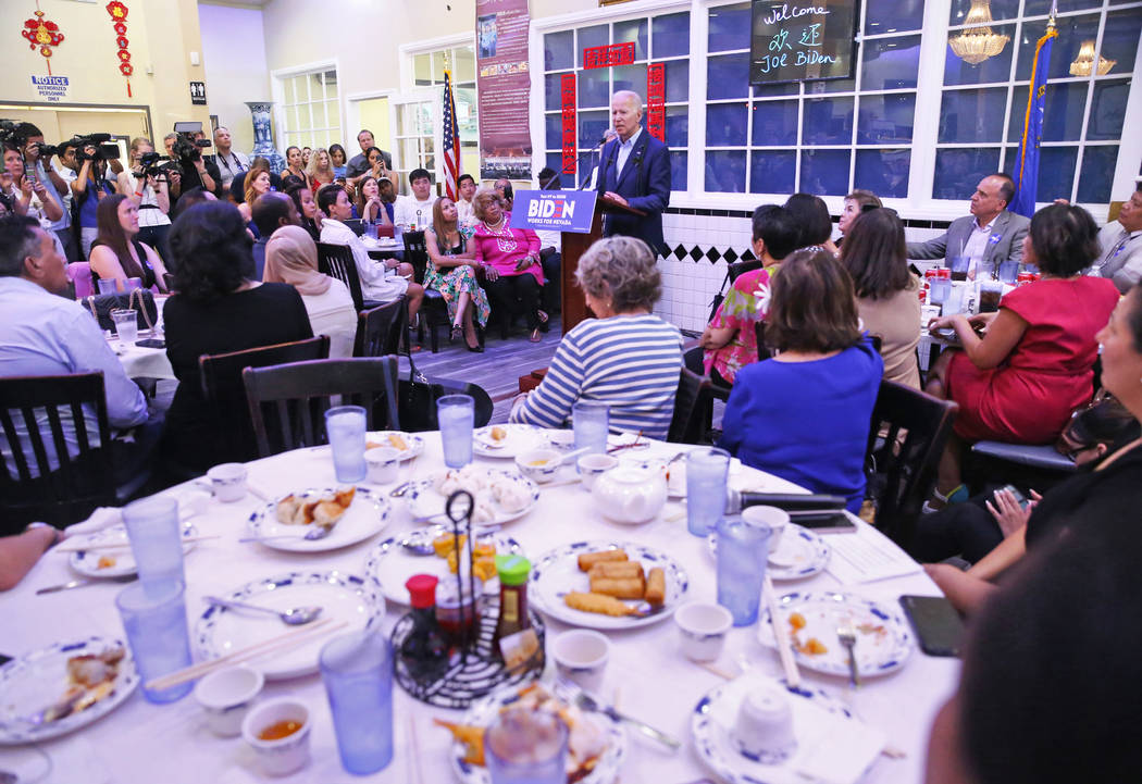 Attendees listen to Democratic presidential candidate former Vice President Joe Biden, top/midd ...