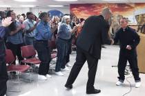 Democratic presidential candidate Sen. Cory Booker, D-N.J., shakes hands with an inmate on Satu ...