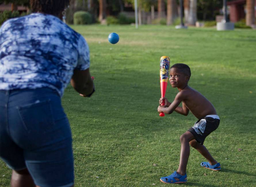 Maureen Edwards tosses a ball to her grandson Xavier Love, 6, at Lorenzi Park in Las Vegas, Sun ...