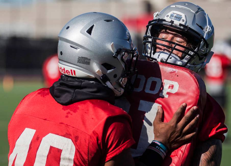 UNLV linebacker Vic Viramontes, right, works through drills during the first day of training ca ...