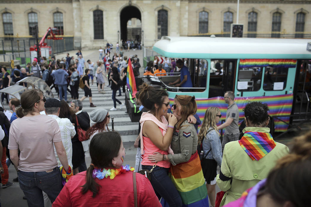 FILE - In this Saturday, July 2, 2016 file photo people hug during the annual Gay Pride march i ...