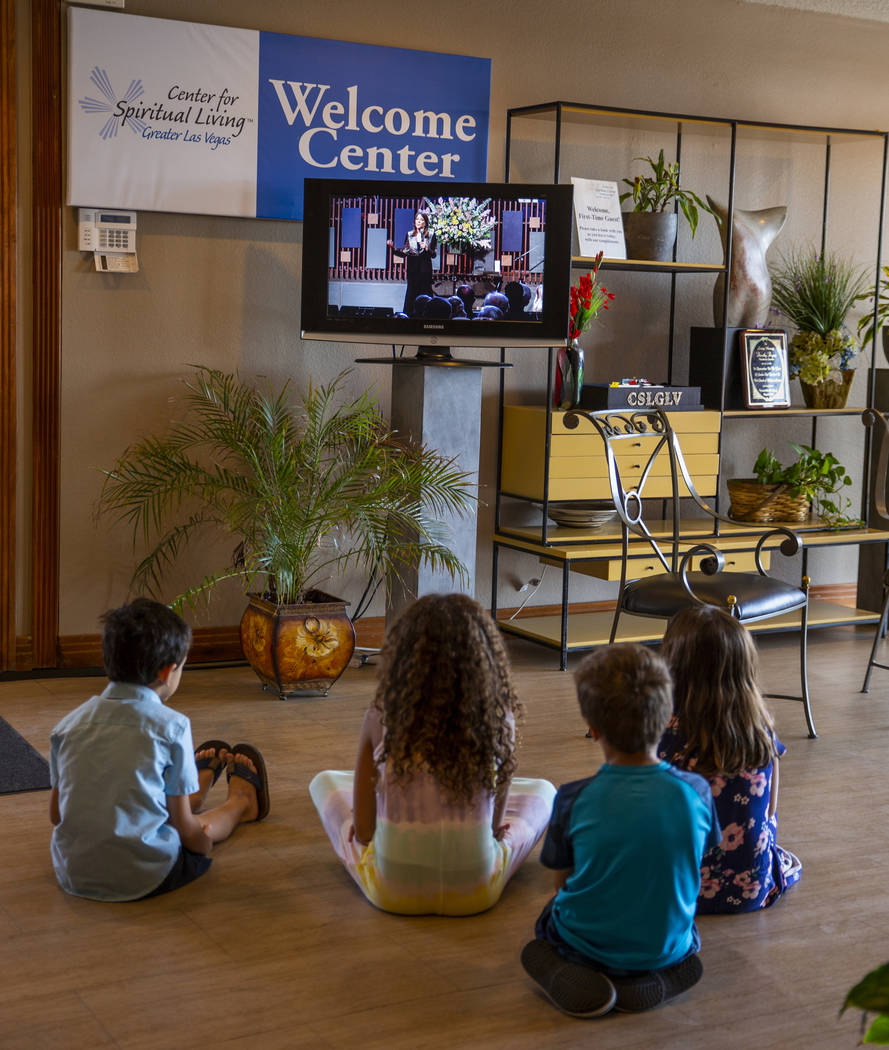 Kids watch from the lobby as Democratic presidential candidate Marianne Williamson speaks to th ...