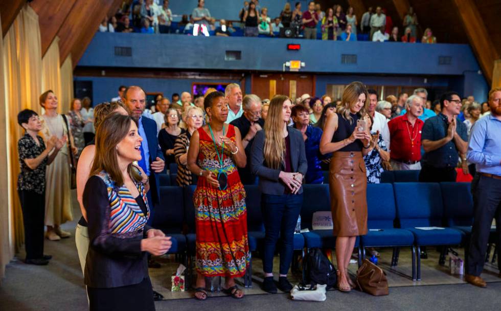 Democratic presidential candidate Marianne Williamson, center in front, joins the congregation ...