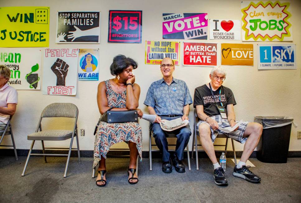 Lorraine Brown, Michael Nussbaum and Gary Vesperman, from Boulder City, sit as they wait for a ...