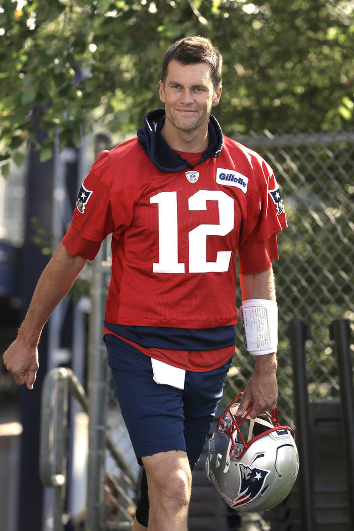 New England Patriots quarterback Tom Brady steps on the field at the start of an NFL football t ...