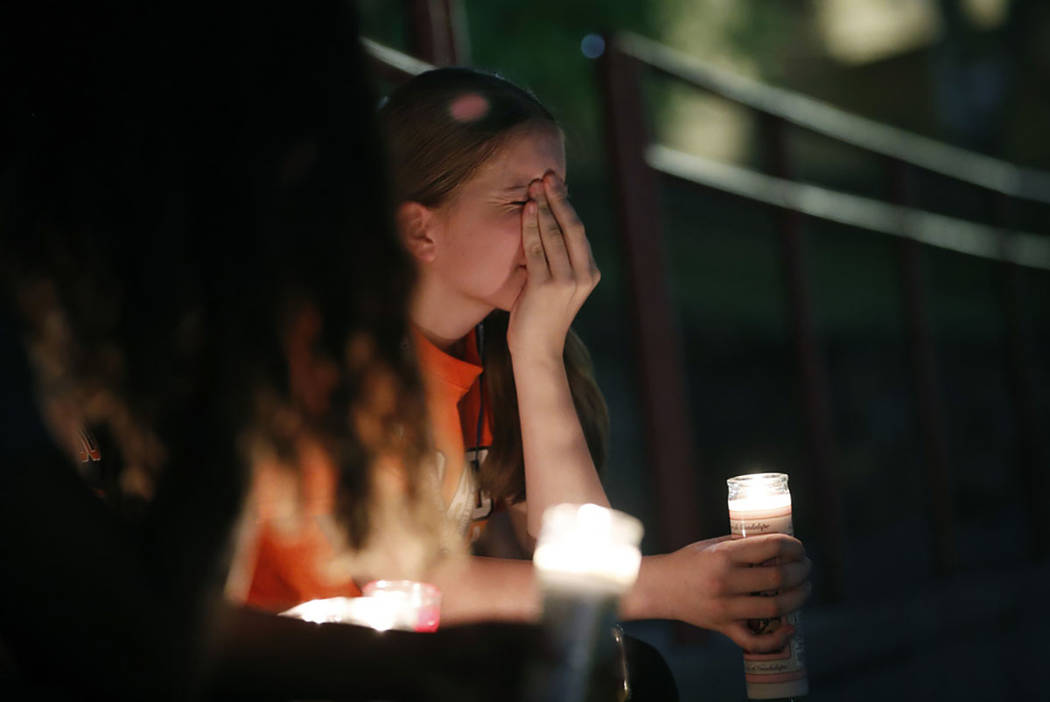 Sherie Gramlich reacts during a vigil for victims of a mass shooting that occurred earlier in t ...