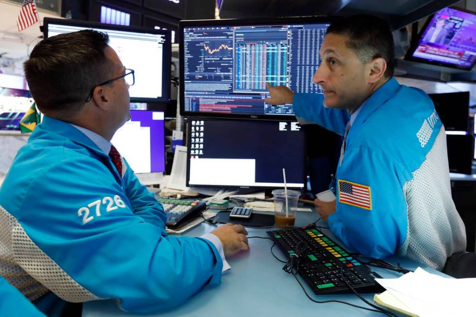 Specialists Paul Cosentino, left, and Jeffrey Berger work on the floor of the New York Stock Ex ...