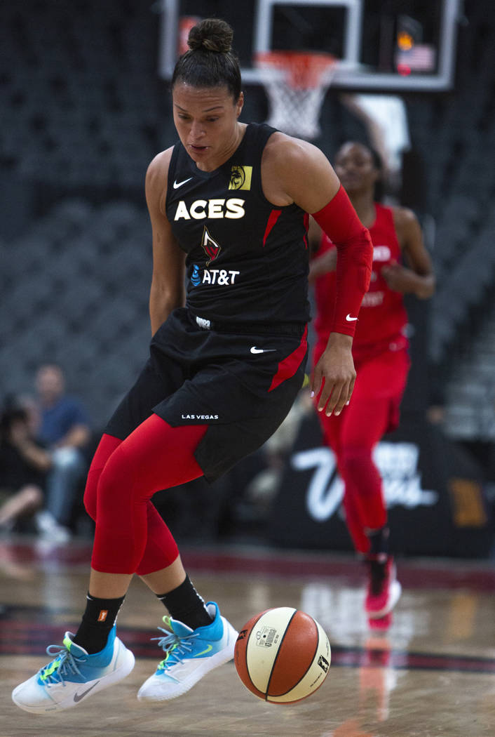 Las Vegas Aces guard Kayla McBride (21), does a crossover against Washington Mystics players at ...