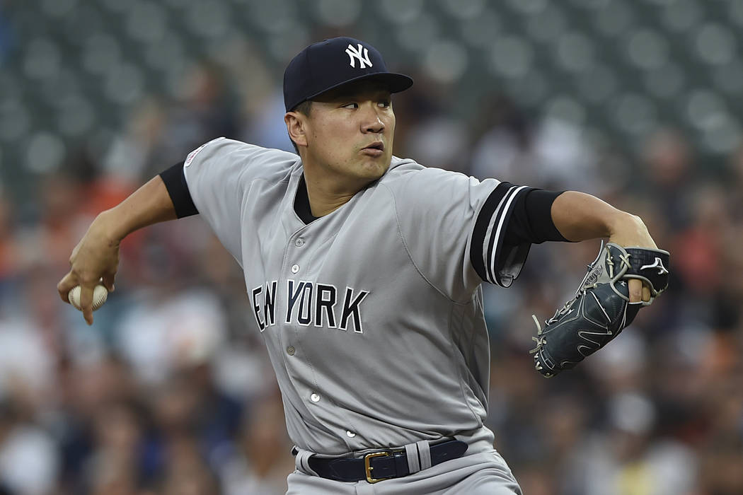New York Yankees pitcher Masahiro Tanaka throws to the Baltimore Orioles in the first inning of ...
