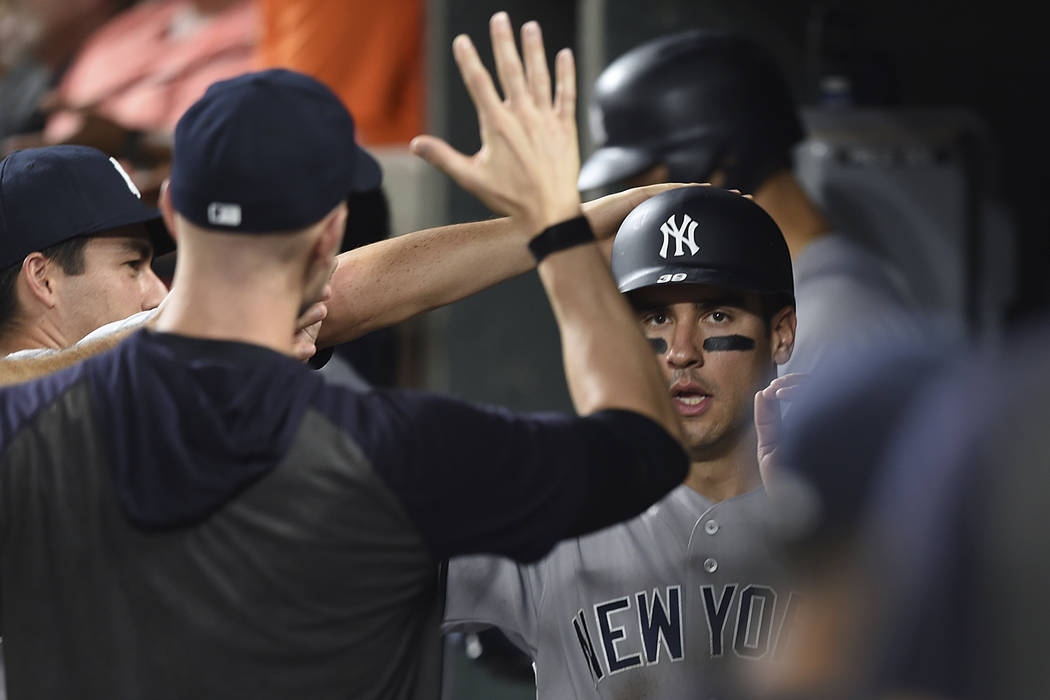 New York Yankees' Mike Tauchman is congratulated after scoring against the Baltimore Orioles in ...