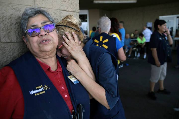 In an Aug. 3, 2019, file photo Walmart employees react after an active shooter opened fire at t ...