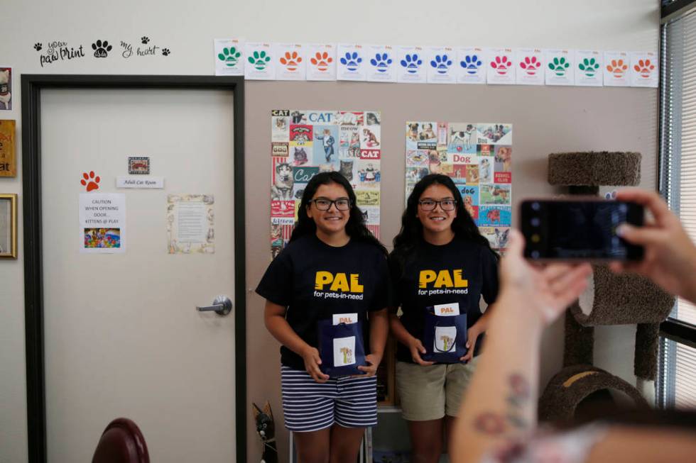 Anaisa, left, and Malena Maestas, 13, get their photo taken during the soft launch at the Rescu ...