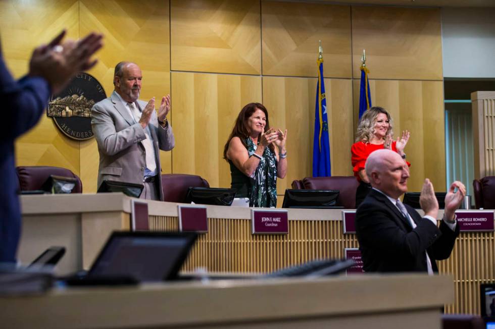 Henderson Mayor Debra March, center, claps alongside councilman John Marz, left, and councilwom ...