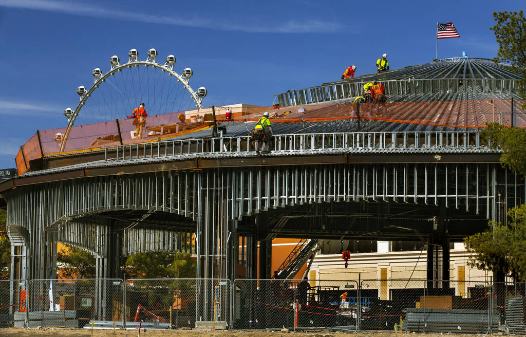 A construction crew works on the roof of a new pavilion at Wynn Golf Club on Tuesday, July 30, ...