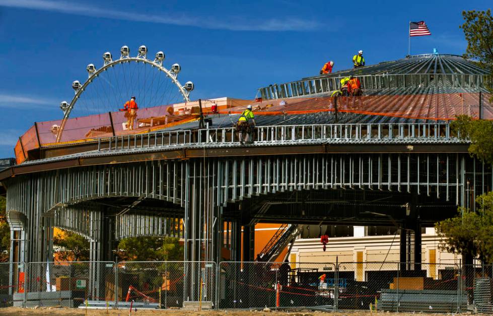 A construction crew works on the roof of a new pavilion at Wynn Golf Club on Tuesday, July 30, ...