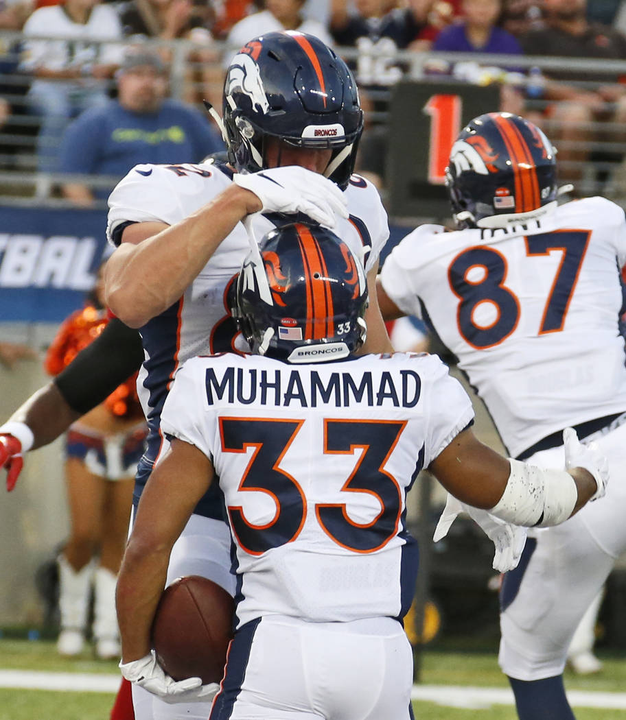 Denver Broncos fullback Andy Janovich, top, congratulates running back Khalfani Muhammad after ...