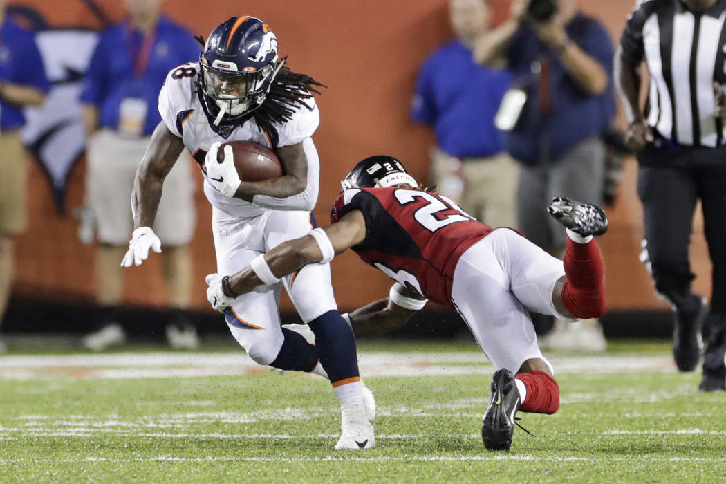 Denver Broncos running back Devontae Jackson (48) breaks a tackle from Atlanta Falcons defensiv ...