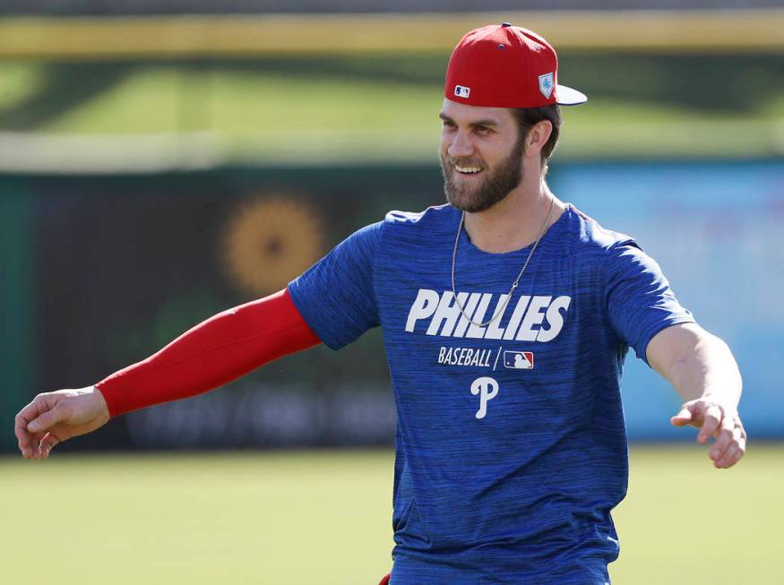 Philadelphia Phillies outfielder Bryce Harper warms up during baseball practice Sunday, March 3 ...